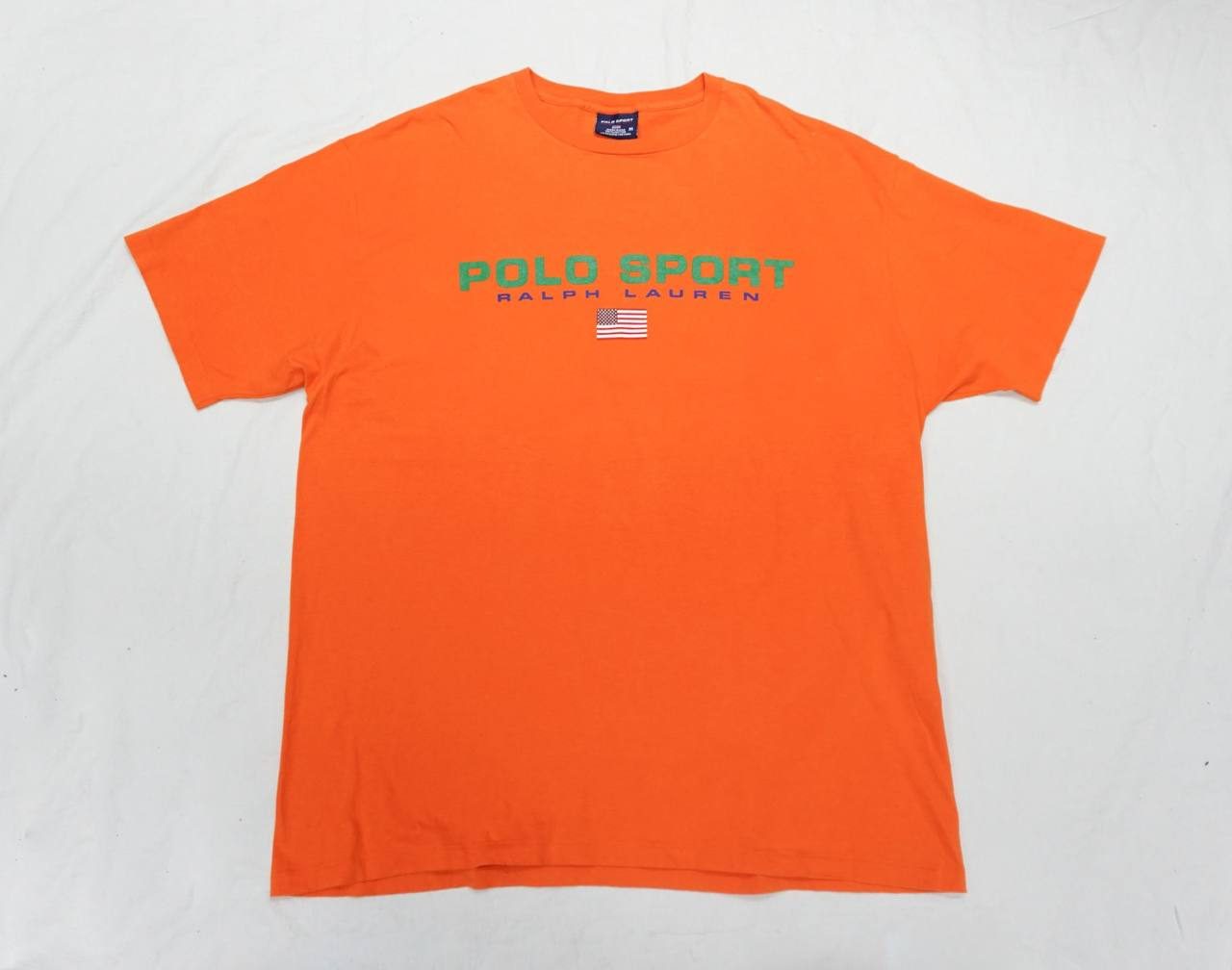 Polo Sport orange tee — flag patch